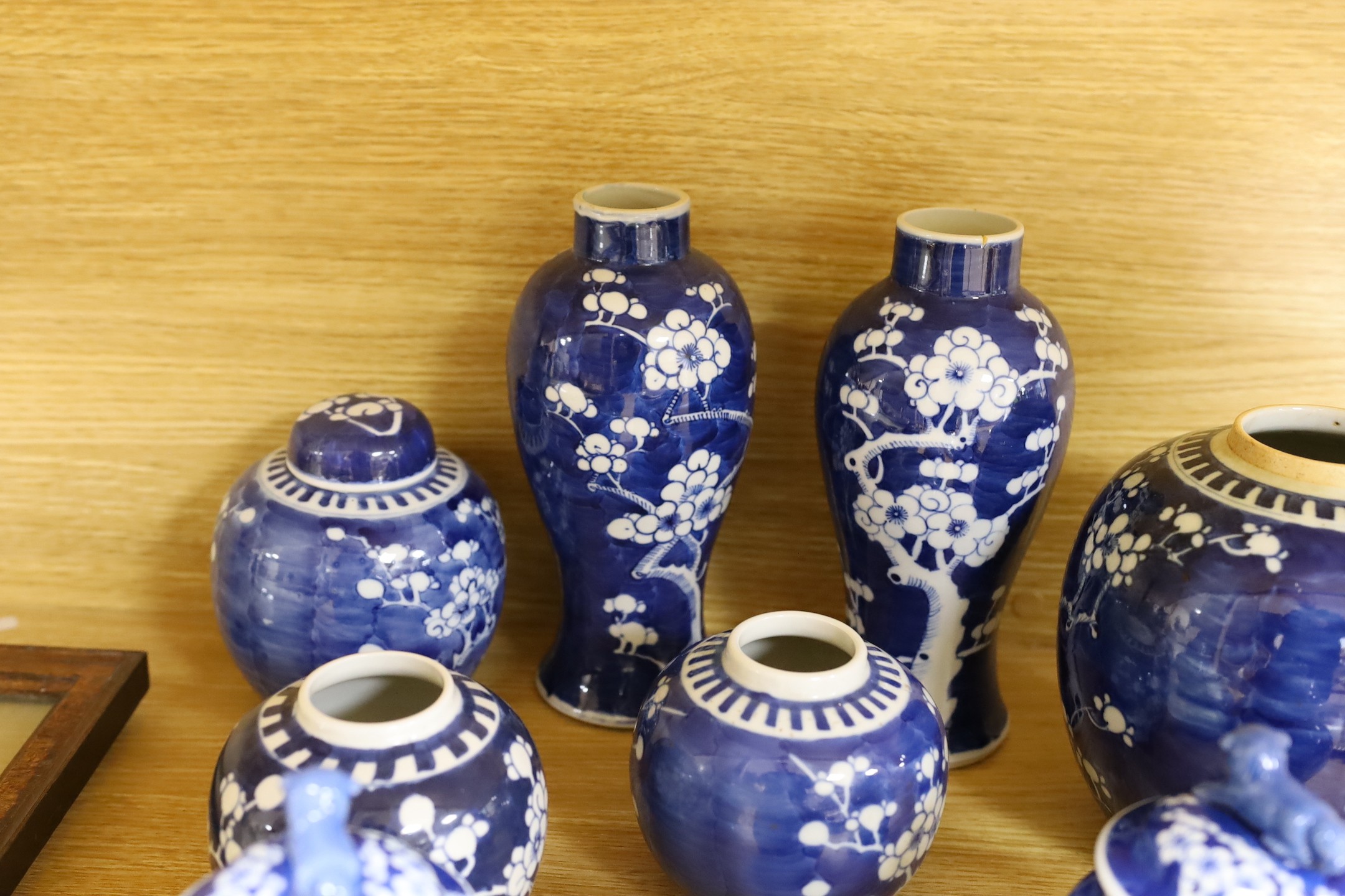 A group of Chinese blue and white prunus vases and jars and covers and jars, pair of vases 23 cms high